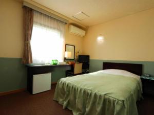 Postel nebo postele na pokoji v ubytování Business Hotel Nishikiryu