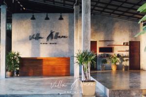 a lobby with a sign that reads ville mère and plants at Villa Allure Koh Mak in Ko Mak