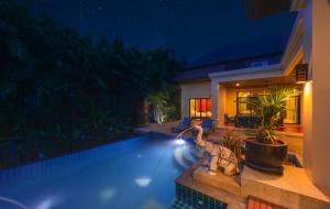 奈漢海灘的住宿－坂巴熱帶景觀別墅，夜间在房子前面的游泳池