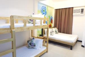 a bedroom with two bunk beds in a room at Kamusta Boutique Hotel in Boracay