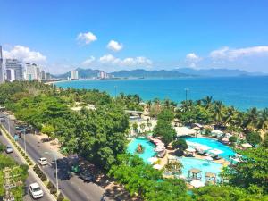 an aerial view of a resort with two pools and the ocean at Anh Minh - Manchester Hotel Tran Phu Beach Nha Trang in Nha Trang
