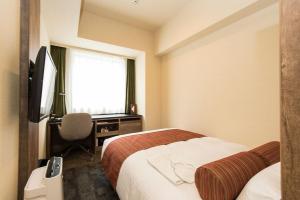 Ένα ή περισσότερα κρεβάτια σε δωμάτιο στο Rembrandt Style Sapporo