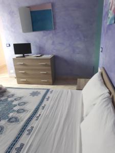 a bedroom with a bed and a dresser with a monitor at Le colline in Capena