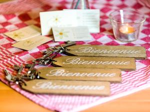 a table with three key chains on top of a table at La Fleur et Le Soleil (F&S) in Durbuy