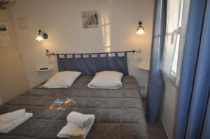 a bedroom with a bed with two pillows on it at Le Concept Hotel in Les Portes
