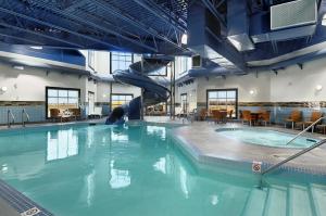 a large swimming pool with a slide in it at Canalta Hotel Moosomin in Moosomin