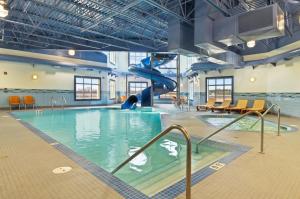 a indoor swimming pool with a slide in a building at Canalta Hotel Humboldt in Humboldt