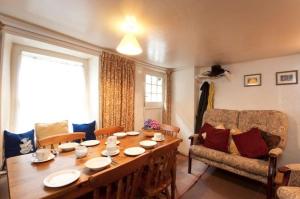 a living room with a table and a couch at Fishermans Cottage in Port Isaac