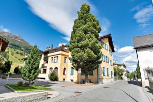 a large tree in front of a building at Chesa Cromer - Celerina in Celerina