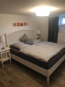 a bedroom with a bed and two tables and a window at Haus Marianne in Ettersburg