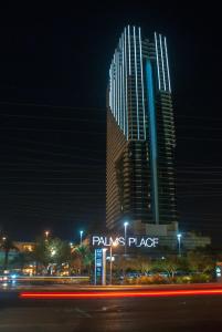 a tall building with a sign in front of it at night at Palms Place Hotel and Spa in Las Vegas