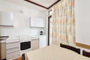 a small kitchen with a table and a kitchen at Apartments Astra Plava Laguna in Poreč