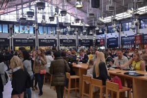 a crowd of people standing in a room with tables at Anthony's Place in Almada