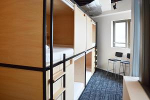 a room with bunk beds and a table at Guest House Tokyo Azabu in Tokyo