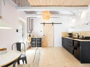a kitchen with a table and a door in a room at Chatka w trawach in Krakow