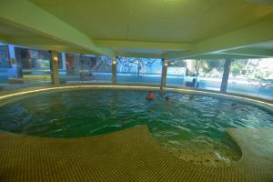 a swimming pool with two people in the water at Chau Long Sapa 2 Hotel in Sapa