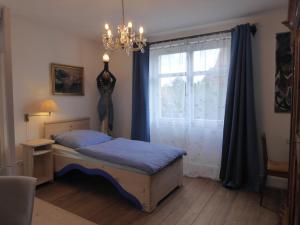 a bedroom with a bed and a window at Pension Zur Rose in Weil am Rhein