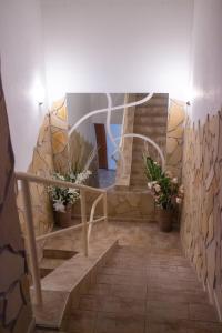 a staircase in a building with potted plants at Penzion Axa in Hradec Králové