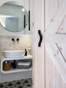 a bathroom with a white sink and a mirror at Chatka w trawach in Kraków