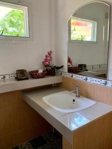 a bathroom with a sink and a mirror at Pakmeng Beach Resort in Pak Meng