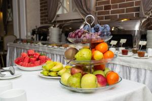 a table topped with bowls of fruit and vegetables at Hotel Imereti in Kazan