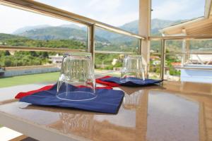 dos copas de vino sentadas sobre una mesa en Ionian Seaview, en Himare