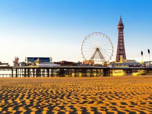 a view of the beach with a ferris wheel in the background at The Royal Boston Hotel in Blackpool