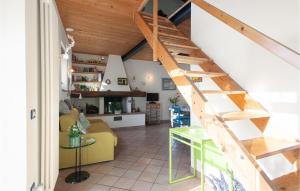 a living room with a wooden staircase in a house at Stunning Home In S,giuliano Terme Pi With 1 Bedrooms, Jacuzzi And Wifi in Asciano Pisano