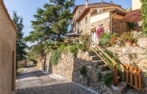 a house with a stone wall and stairs at Stunning Home In S,giuliano Terme Pi With 1 Bedrooms, Jacuzzi And Wifi in Asciano Pisano