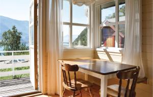 a table and two chairs in a room with a window at 3 Bedroom Lovely Home In Vallavik in Vangsbygd