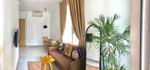 a living room with a couch and a plant at Minh Apartment in Danang