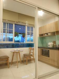 a kitchen with a table and a table and chairs at Minh Apartment in Danang