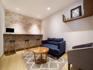 a living room with a blue couch and a table at Hotel Monarca in Mexico City