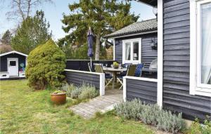 a backyard with a table and a house at Gorgeous Home In Skivarp With Sauna in Skivarp