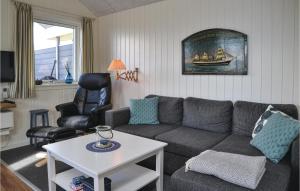 a living room with a couch and a table at Pet Friendly Home In Esbjerg V With House Sea View in Esbjerg
