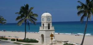 a clock tower on the beach next to the beach at Hemingway Suites at Palm Beach Hotel Island in Palm Beach