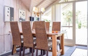 a dining room with a wooden table and chairs at Awesome Home In Blåvand With Wifi in Blåvand