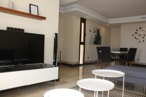 A television and/or entertainment centre at 110 - Beach Two-Bedroom Apartment
