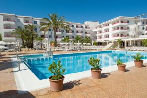 a swimming pool in front of a hotel at Coral Star Hotel in San Antonio Bay