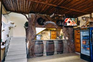 a kitchen with a bar with wine barrels at Готель Hunter in Shegyni