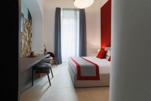 Bespoke Roma Suites في روما: غرفة في الفندق بها سرير ومكتب ومكتب