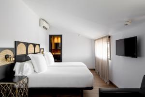 Postel nebo postele na pokoji v ubytování Hotel Astoria