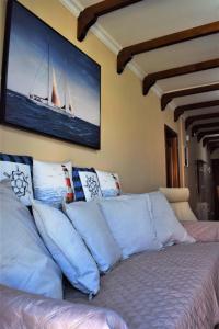 コスタ・デル・シレンチオにあるVictoria Family Apartman Tenerifeの帆船の絵が飾られたベッドのある部屋