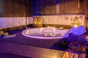 Un baño con bañera y velas. en Parthenon Art Executive Wing, en Olympiakí Aktí 63 fotos más