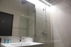 a bathroom with a sink and a shower with a mirror at Hotel Els Avets de Camprodon in Camprodon +22 photos