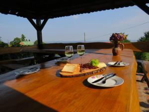 a wooden table with glasses of wine and food on it at Holiday Home Kalnik in Kalnik