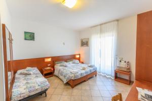 Postel nebo postele na pokoji v ubytování B&B Anna Lungomare