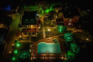 an overhead view of a pool at night with lights at Sunday Resort in Gerakini
