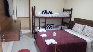 a bedroom with two bunk beds with towels on them at Suites Bella vista in Campos do Jordão