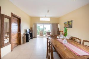 a dining room with a wooden table and a room at Boracay Amor Apartment in Boracay
